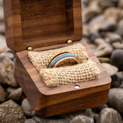 Aeternus rose gold tungsten ring with koa wood and blue opal inlay in a ring box by Natural Rings