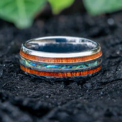 Maris tungsten ring with koa wood and abalone shell inlay on a volcanic rock by Natural Rings