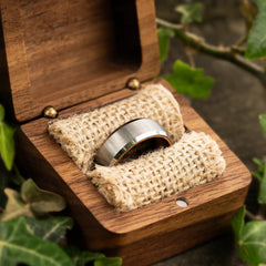 Serenus tungsten ring with koa wood insert in a ring box by Natural Rings