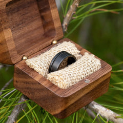 Solus black tungsten ring with guitar string in a ring box by Natural Rings