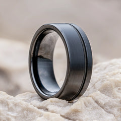 Solus black tungsten ring with guitar string by Natural Rings